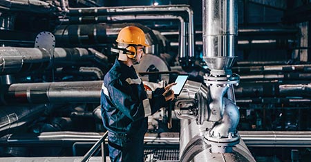 Worker in Heating Plant Working with Mobile Device